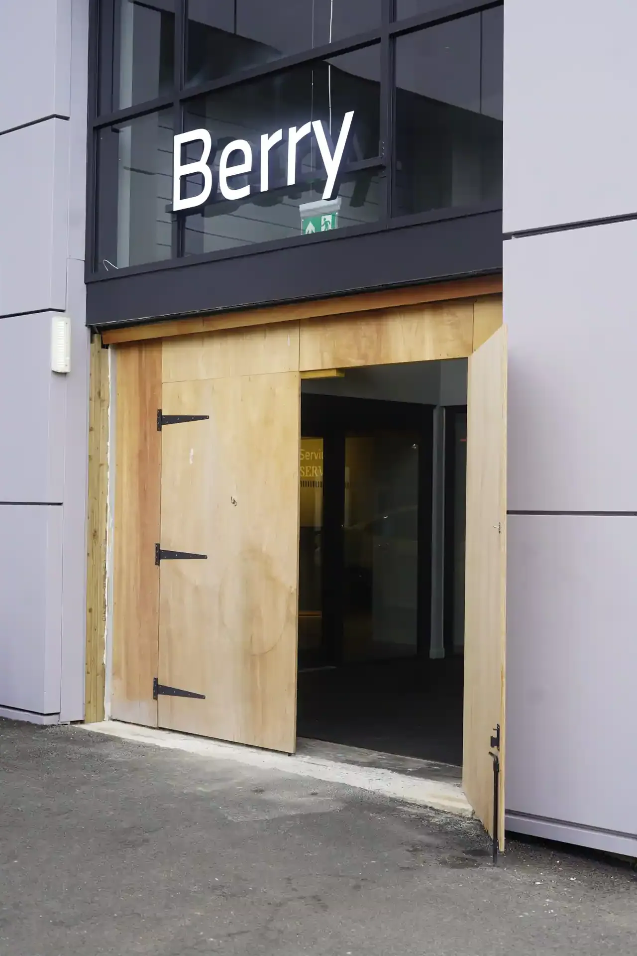 The entrance at BMW Berry Showroom boarded up ahead of the automatic door replacement