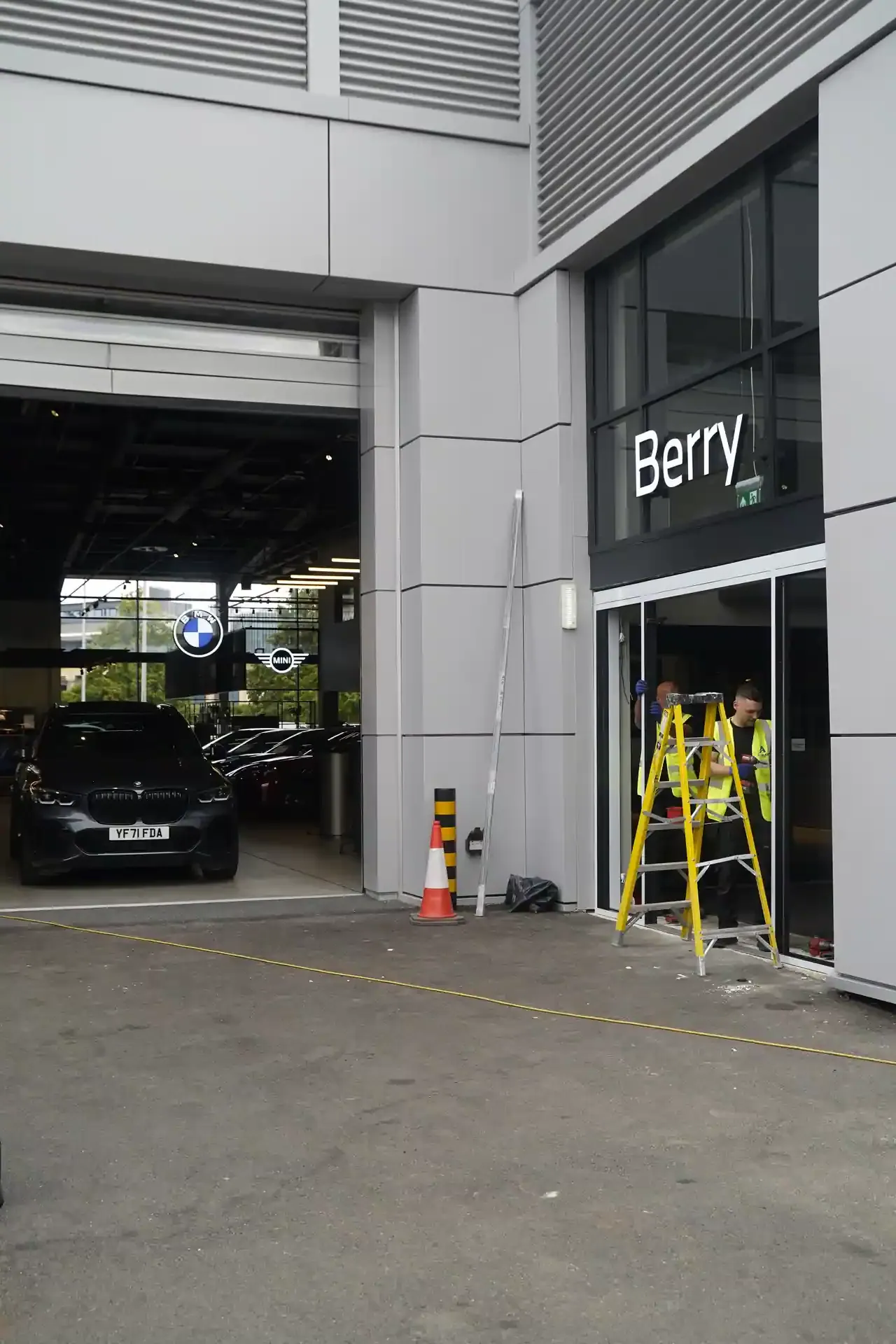 Engineers installing the automatic door system at BMW Berry Showroom
